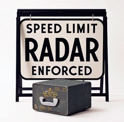 Early radar machine, with a warning sign, first used in the 1950s